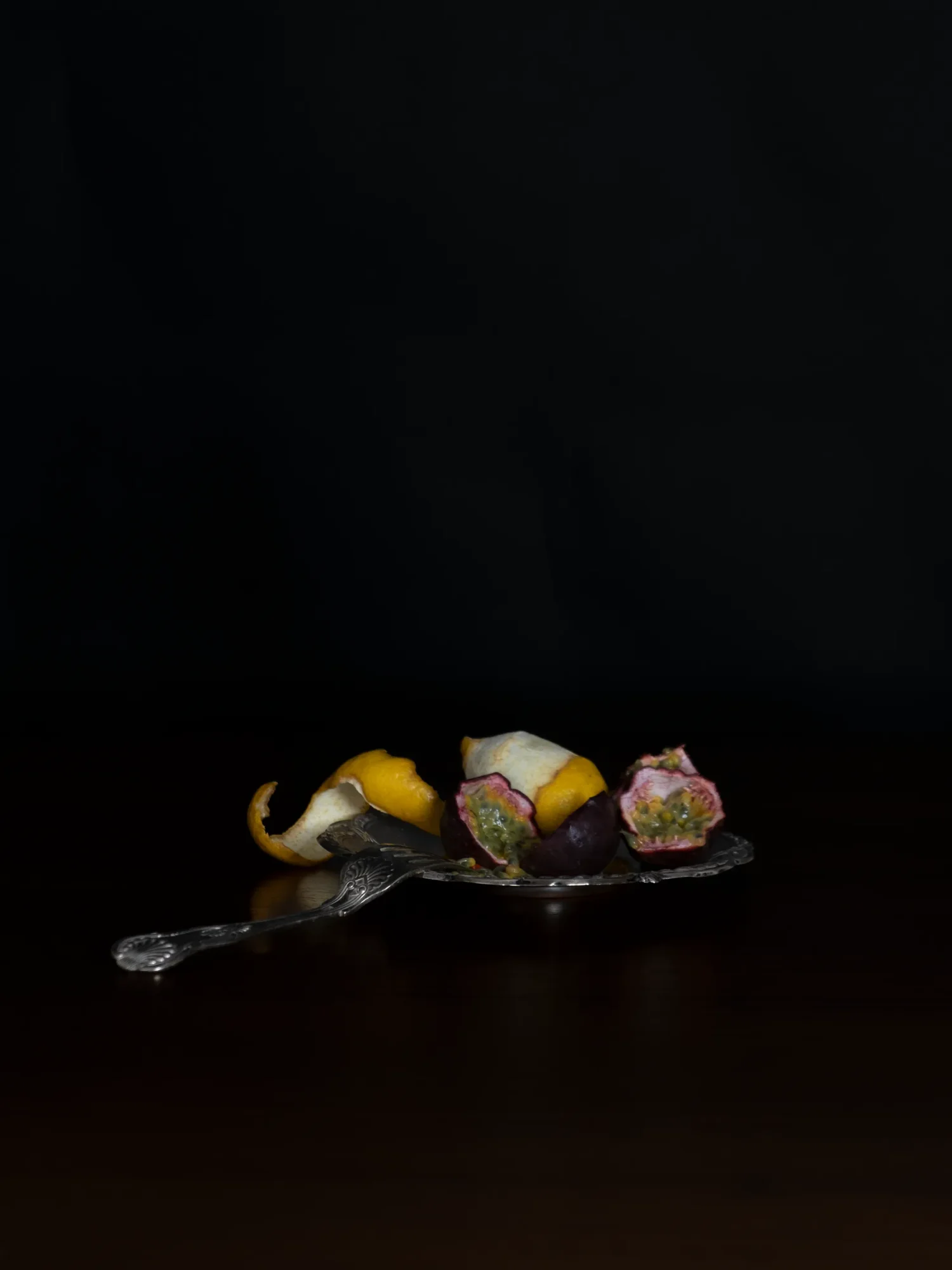 Sliced passionfruit and citrus peel still life